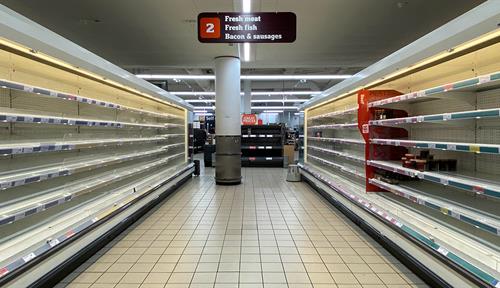 Empty shelves in a UK grocery store during the early weeks of the Covid-19 lockdown in 2020.