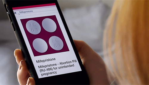 Photo illustration of someone looking at information about mifepristone, used to terminate early pregnancies, on their smartphone.